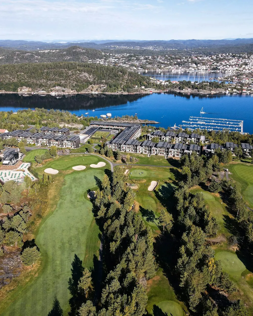 Aerial view of a golf course beside a lake