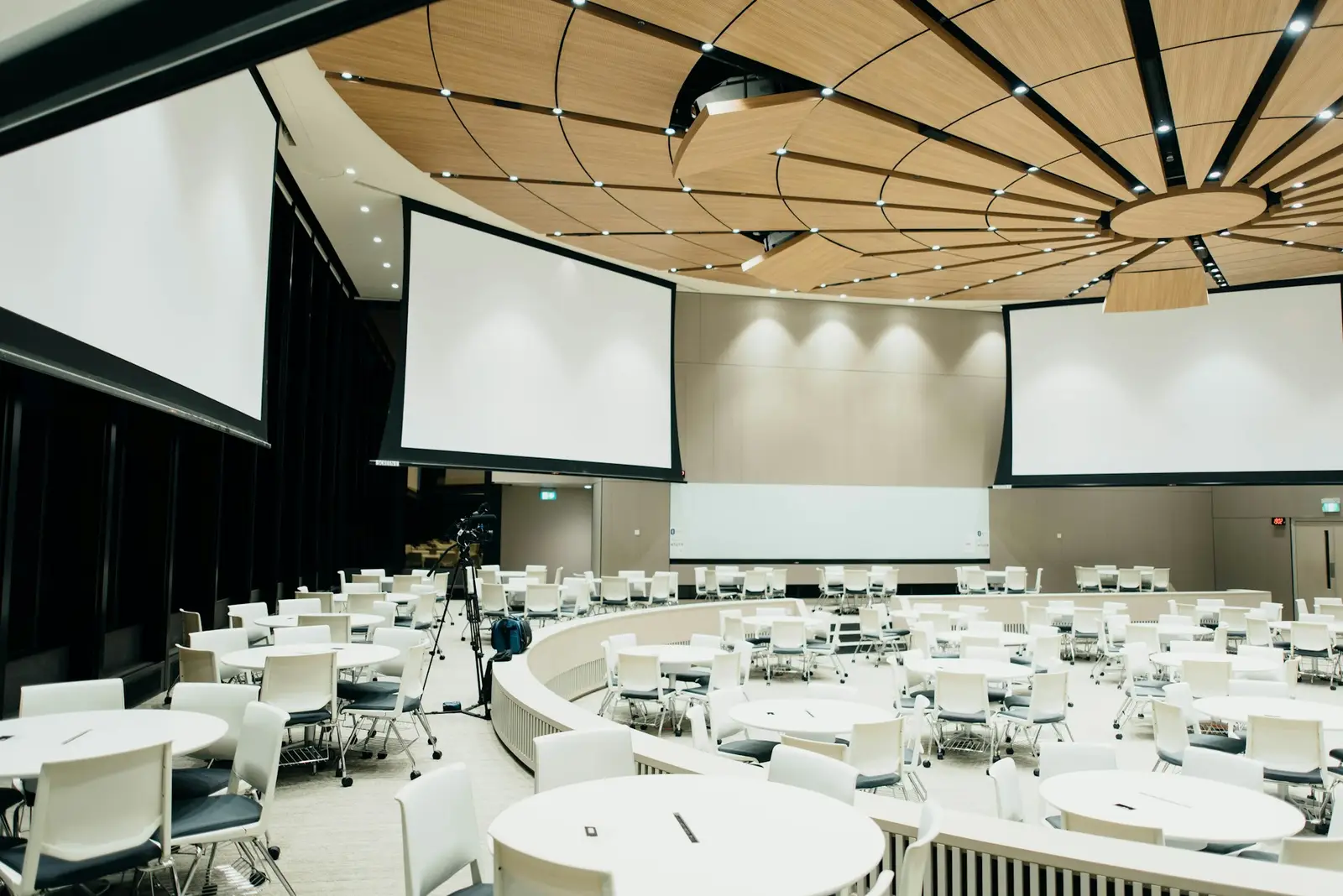 Banquet hall with round tables set for a corporate dinner