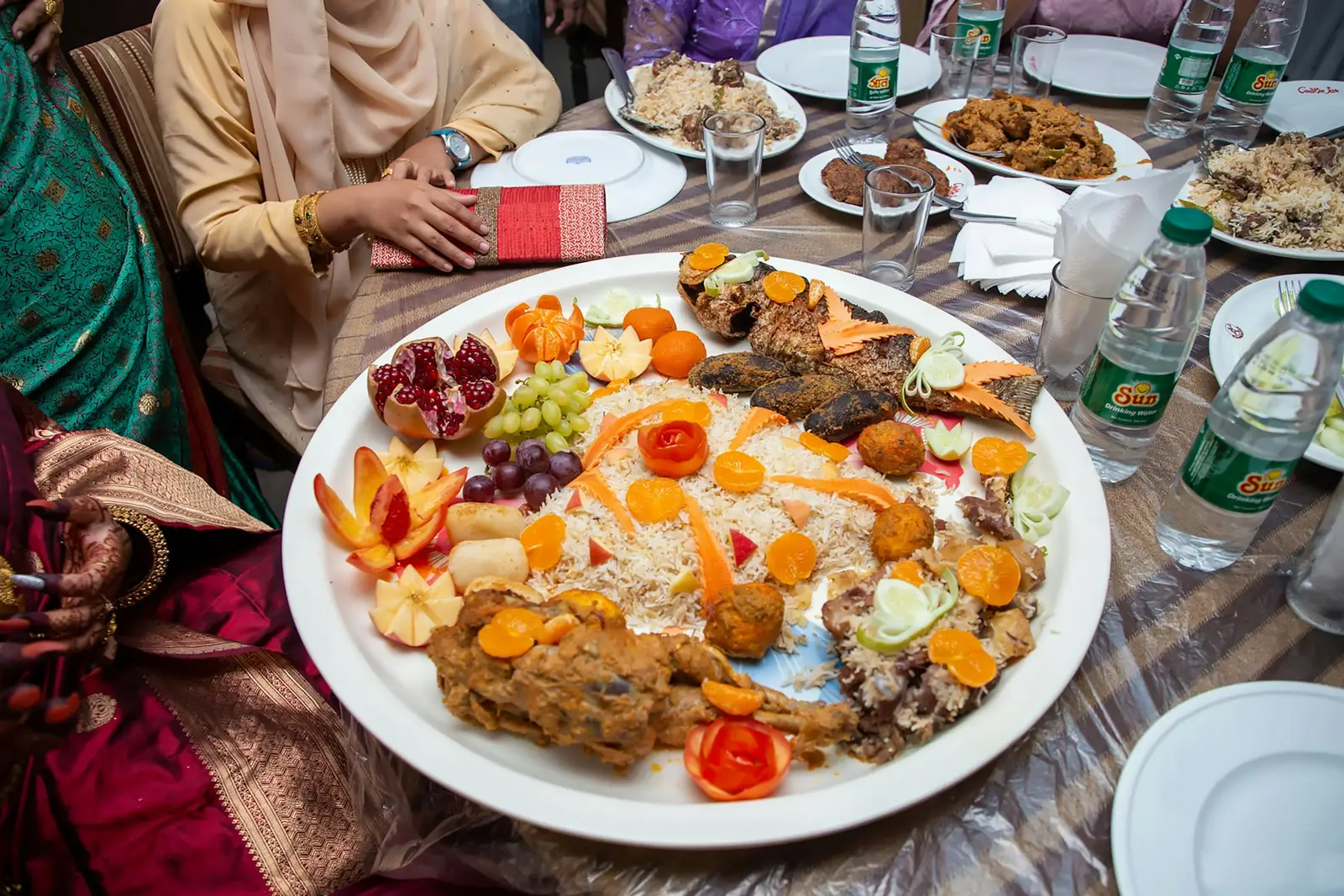 Table set with a large shared rice and meat platter
