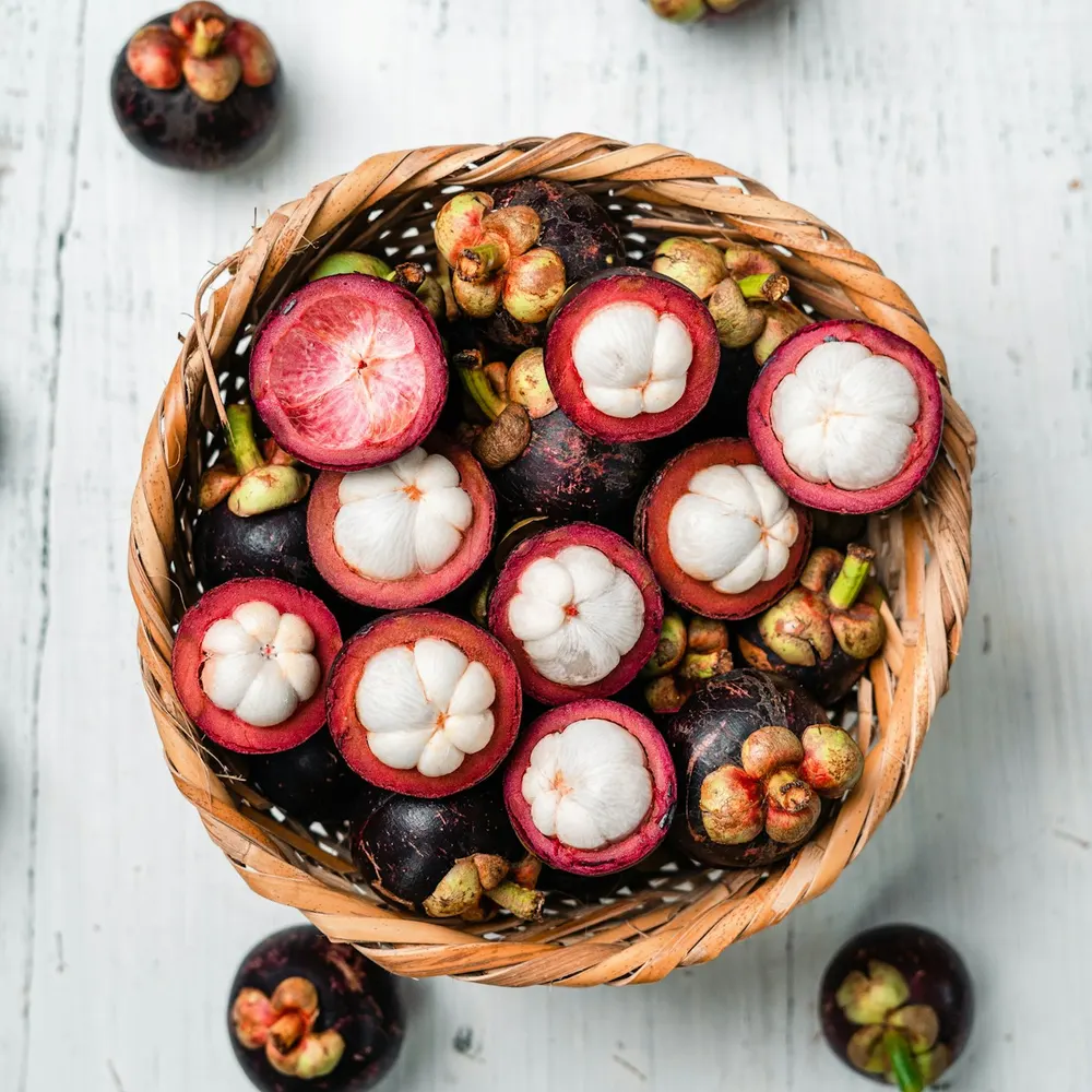 Fresh mangosteens in a woven basket